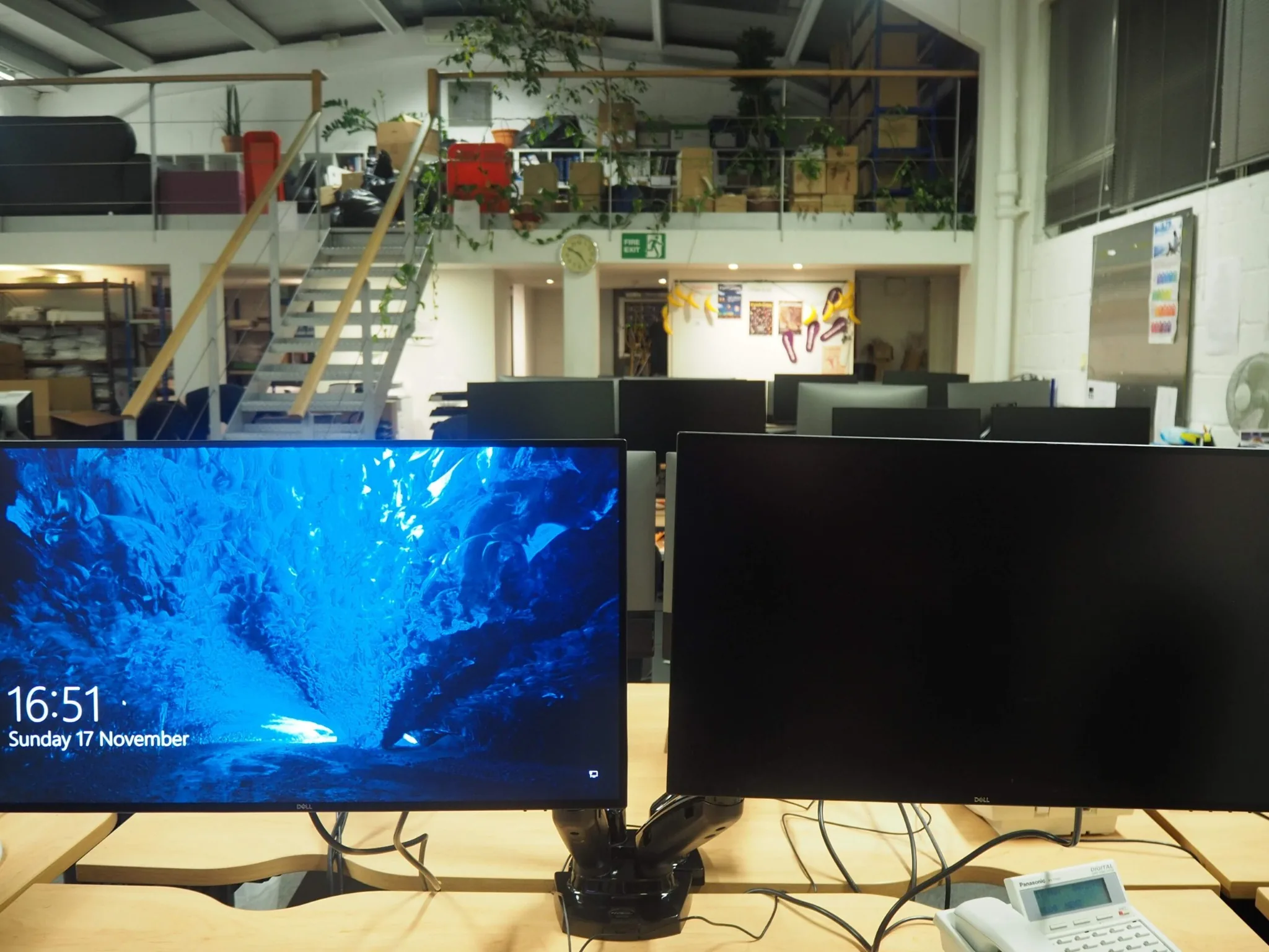 Two monitors and workstations installed in a business office